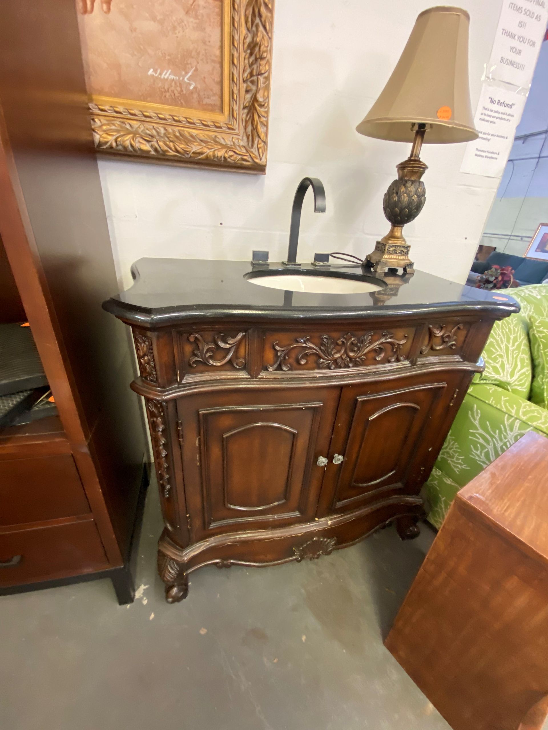 A Woman Is Watering Plants on a Dresser in a Living Room — Lakeland, FL — Thomason Furniture & Mattress