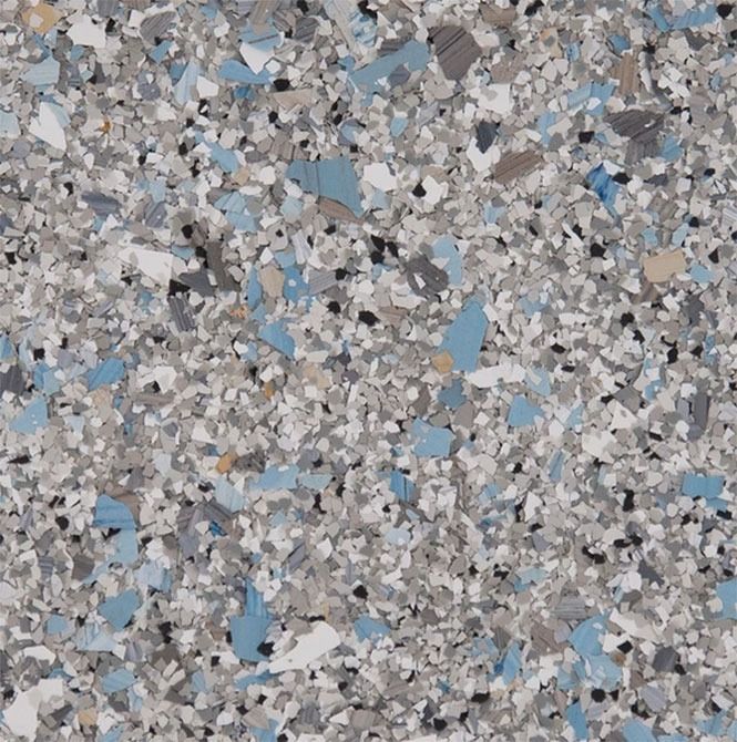 Close-up of speckled floor tile with gray, blue, black, and white chips.