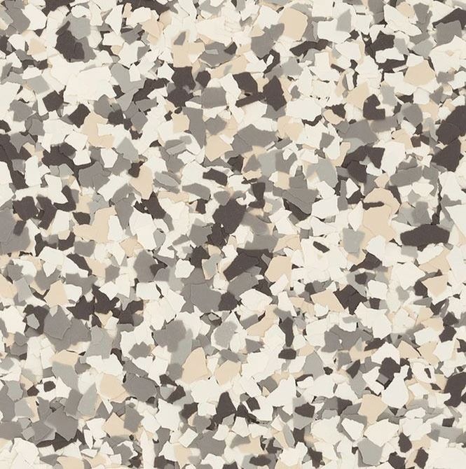 Speckled flooring pattern with tan, gray, and dark brown chips.