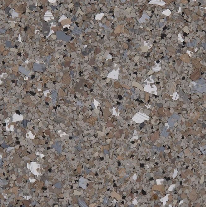 Close-up of speckled floor. Gray, brown, white, and black chips are embedded in a light gray base.