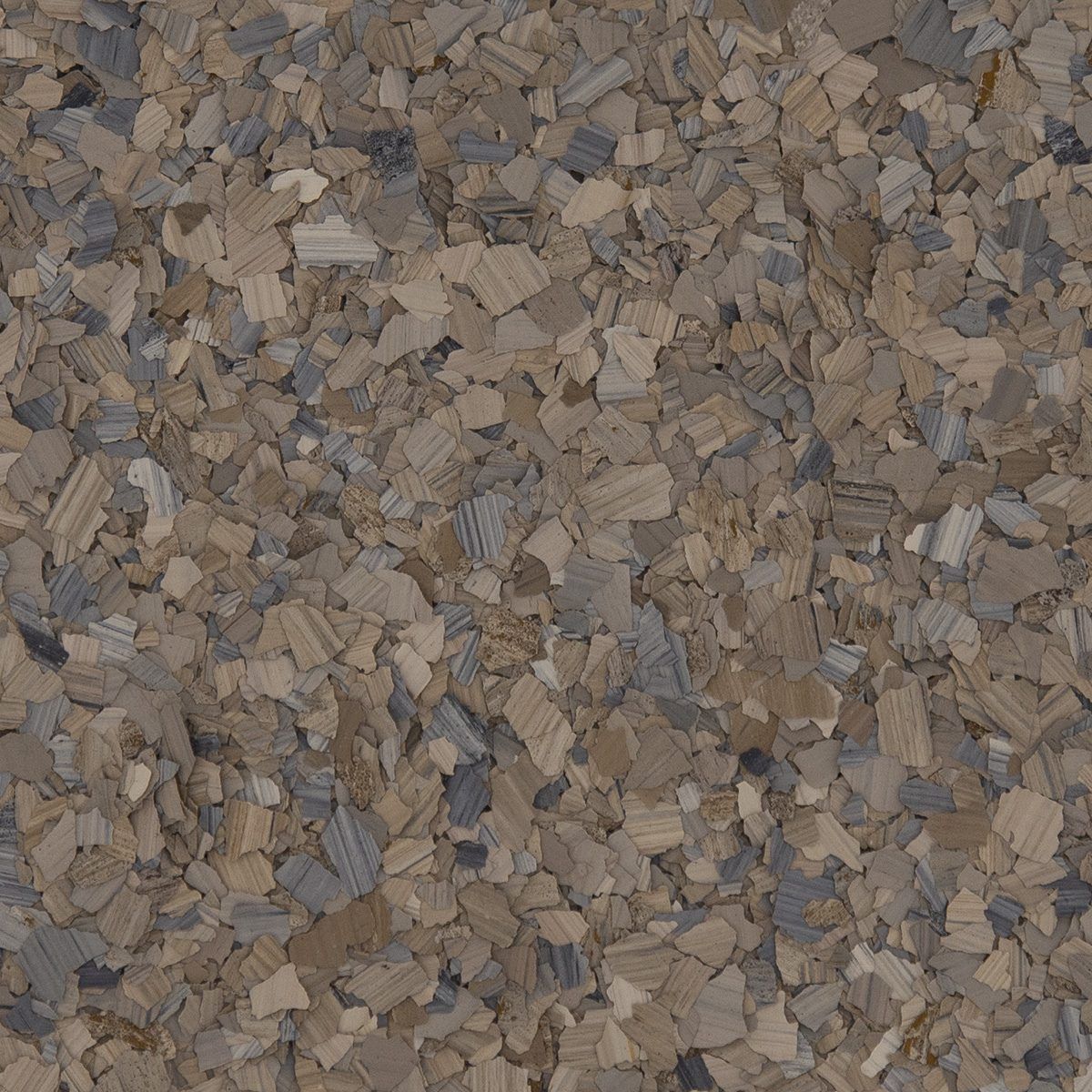 Close-up of small brown and gray wood chips or mulch covering the ground