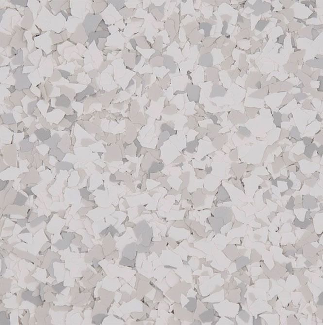 Close-up of a flooring design with a speckled pattern, primarily white and gray chips.