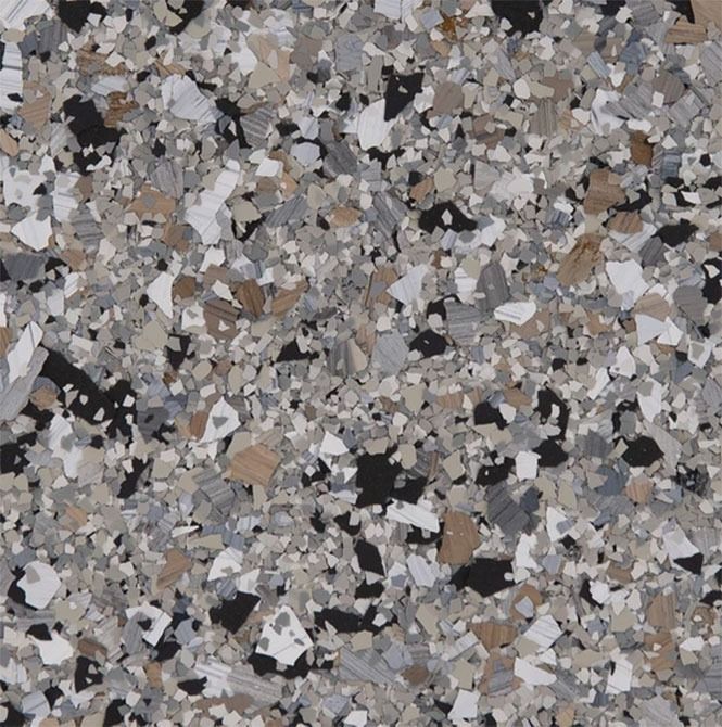 Speckled floor surface with tan, gray, black and white chips.