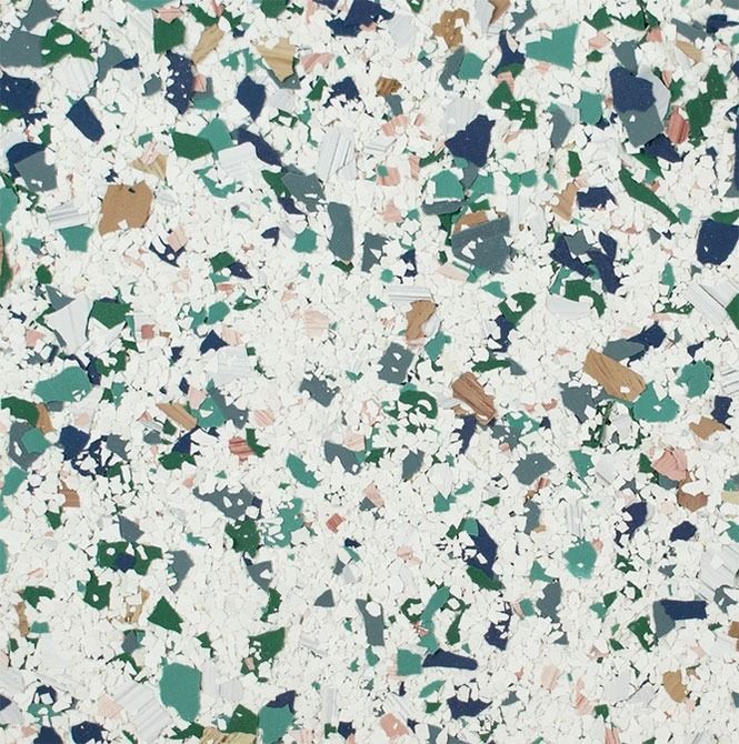 Terrazzo pattern with white background and colorful chips of blue, green, brown, and pink.