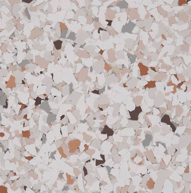 Speckled flooring pattern with white, beige, brown, and gray chips.