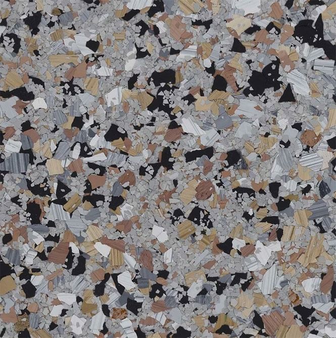 Floor with a speckled pattern of gray, black, gold, and white flakes.