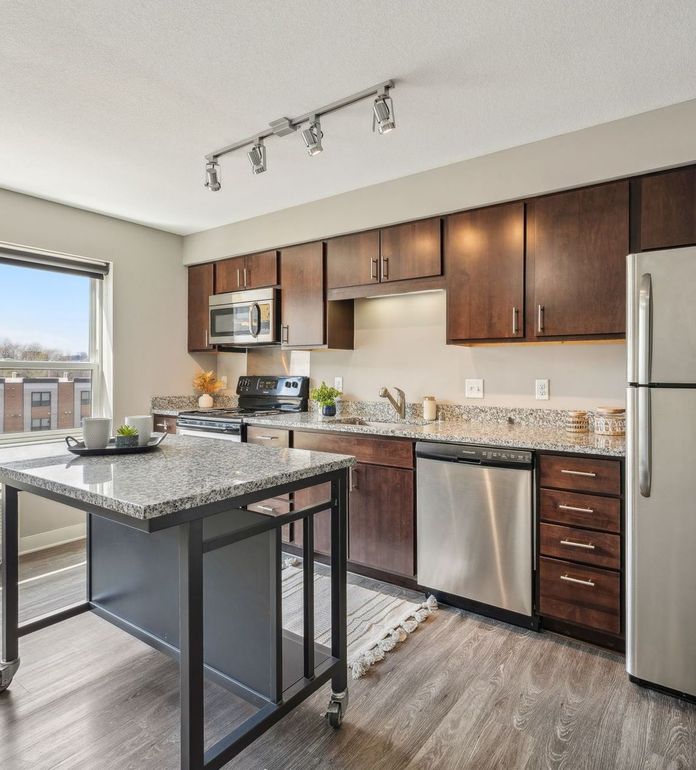 Modern apartment kitchen with stainless steel appliances.