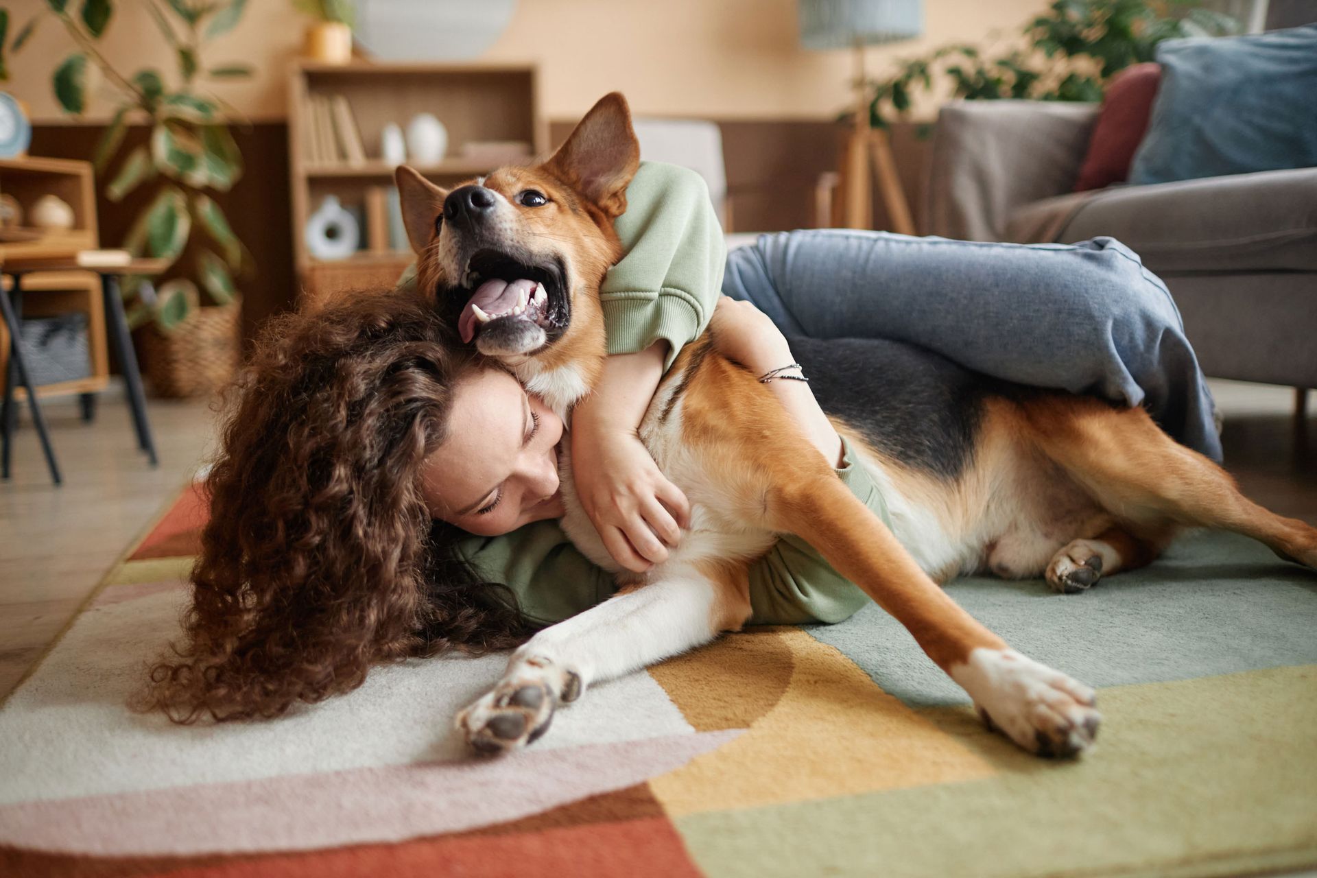 Young woman with a dog laughing