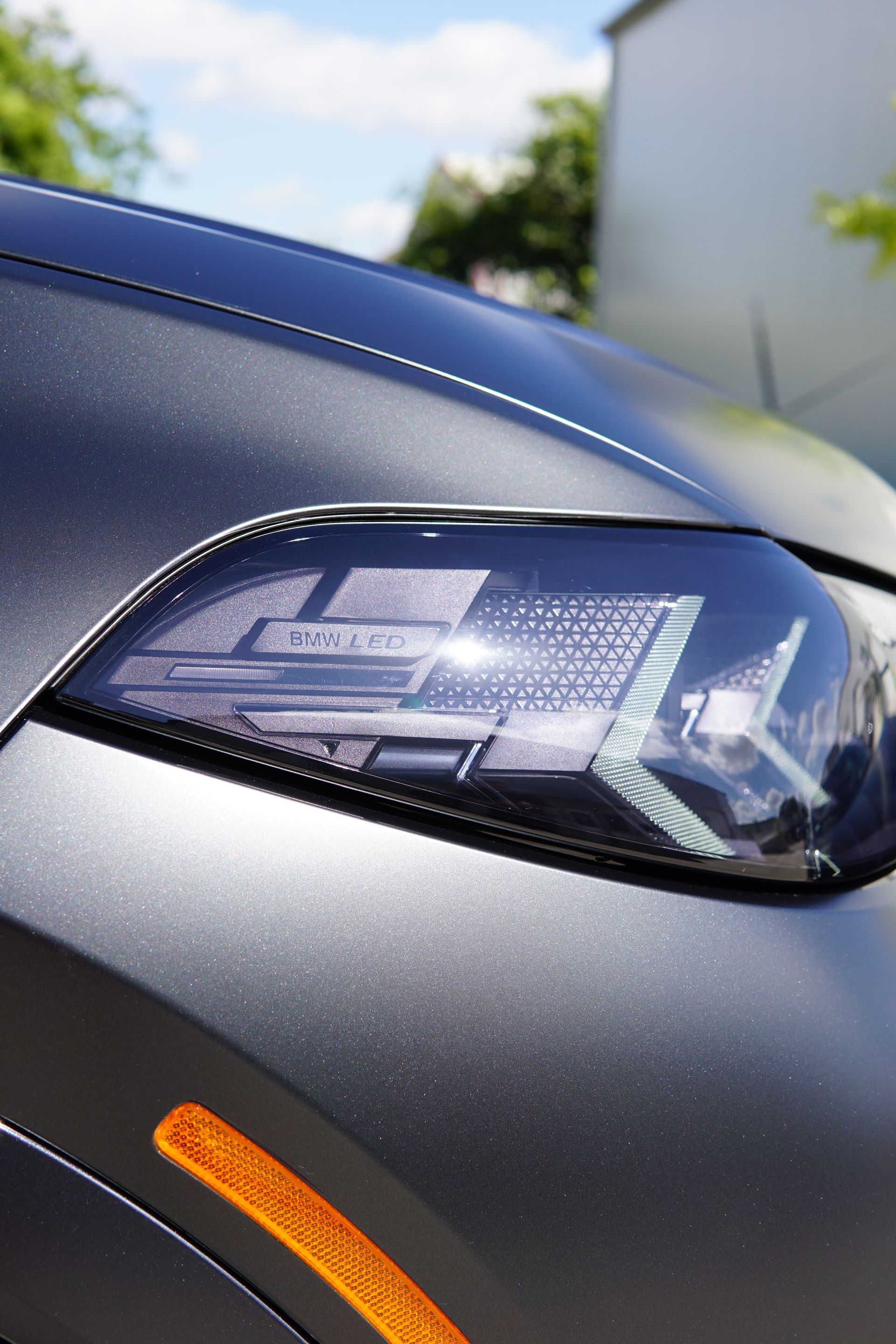 A close up of the headlight of a black car