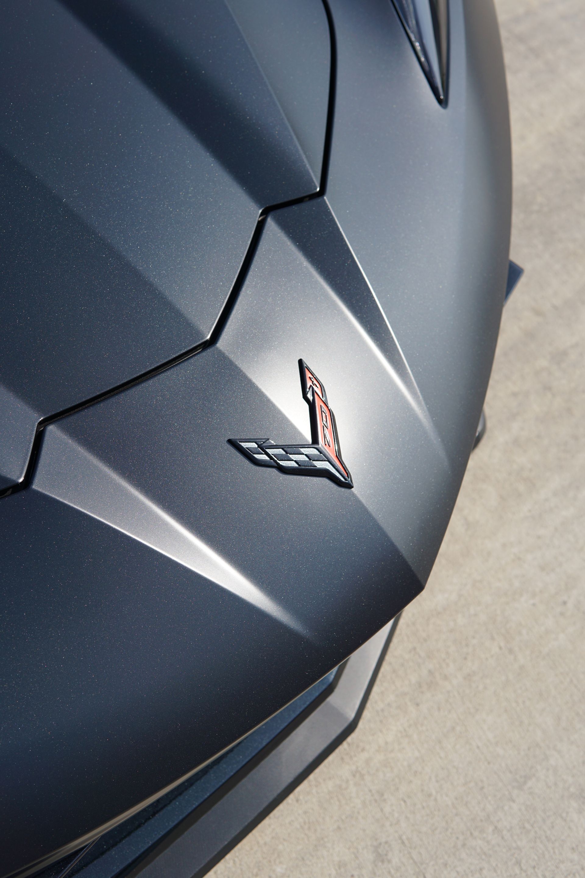 A close up of a corvette emblem on the front of a car