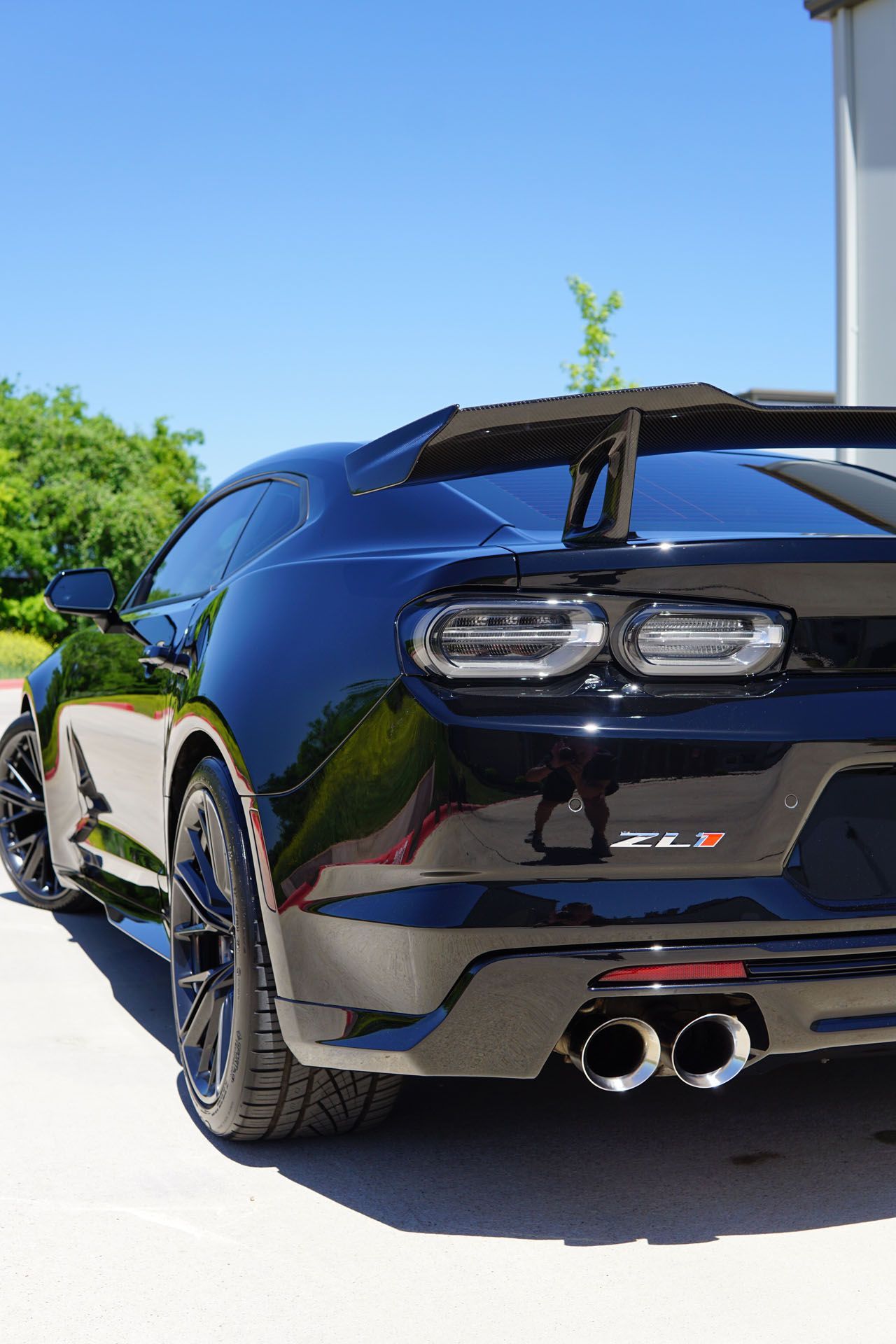 A close up of a blue car parked on the side of the road.