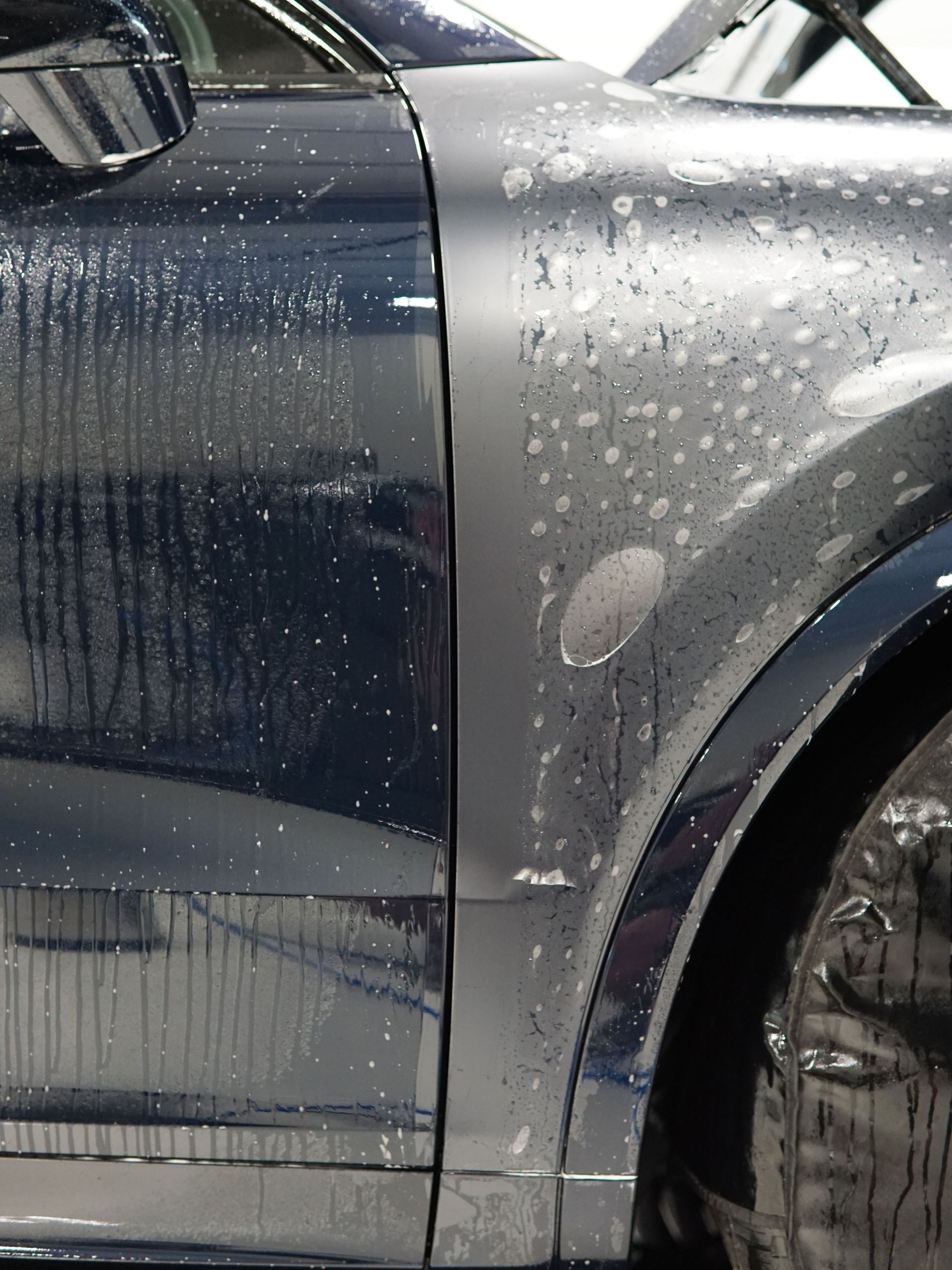 A close up of a car with water drops on it