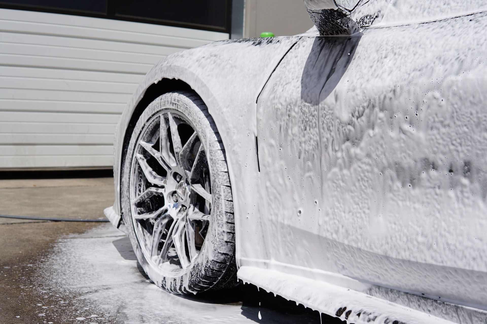 A close up of a car covered in foam.