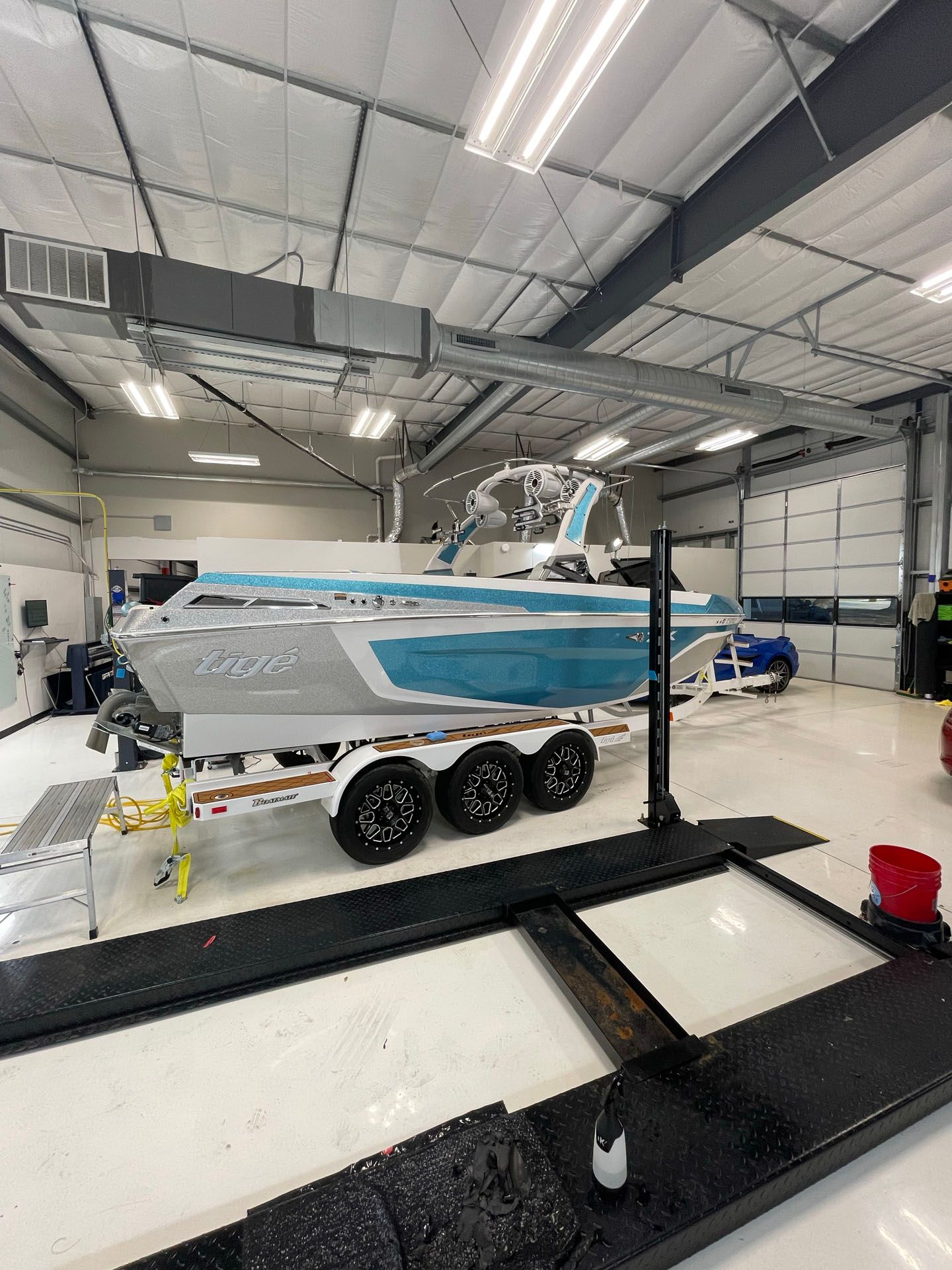 A boat is sitting on a trailer in a garage.