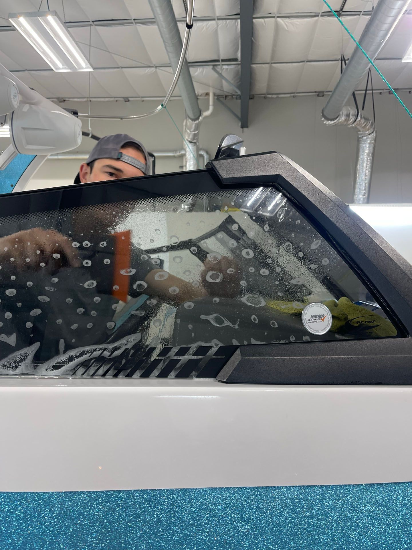 A man is working on a window in a building.