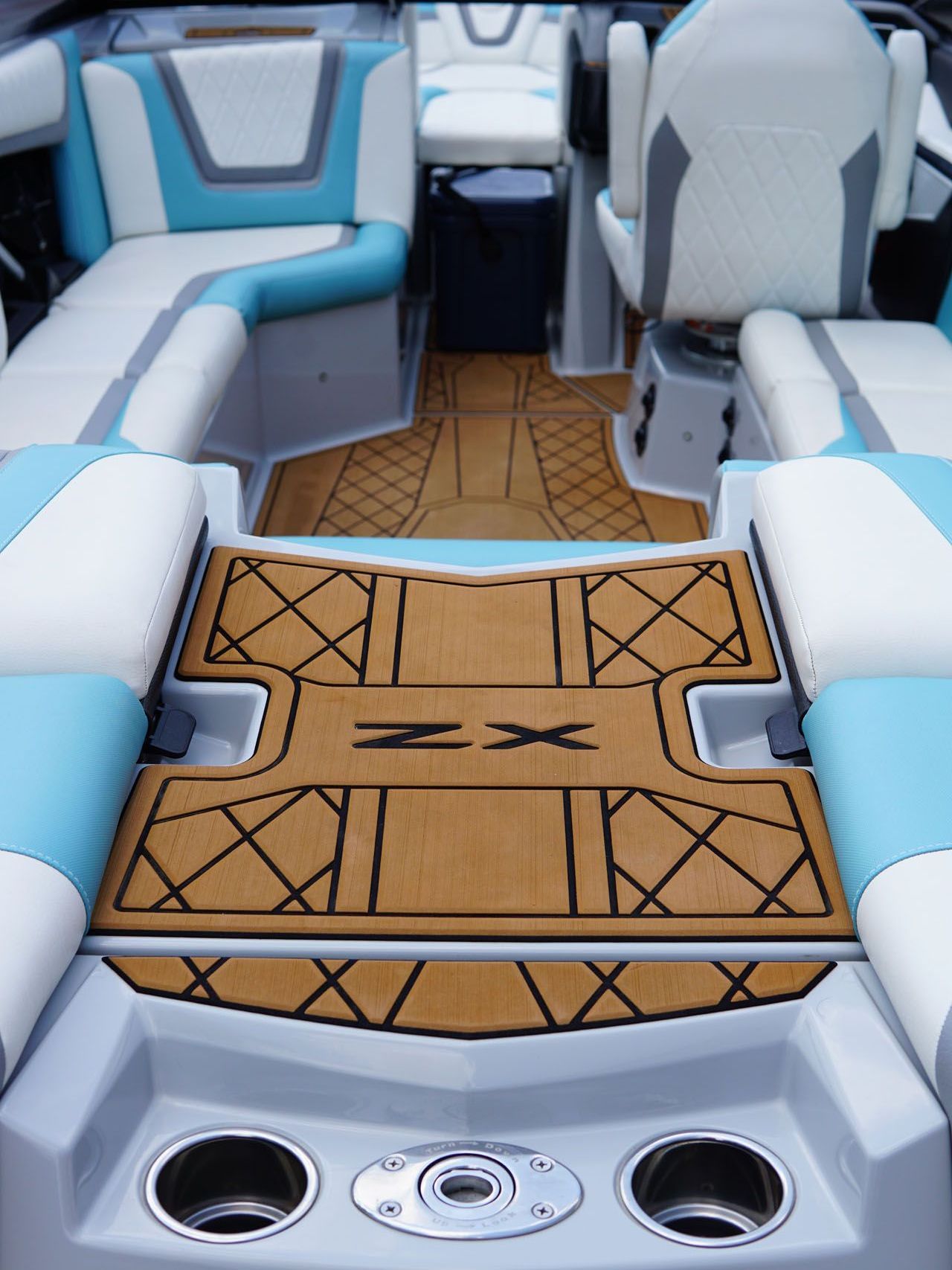 The inside of a boat with a wooden floor that says zx on it