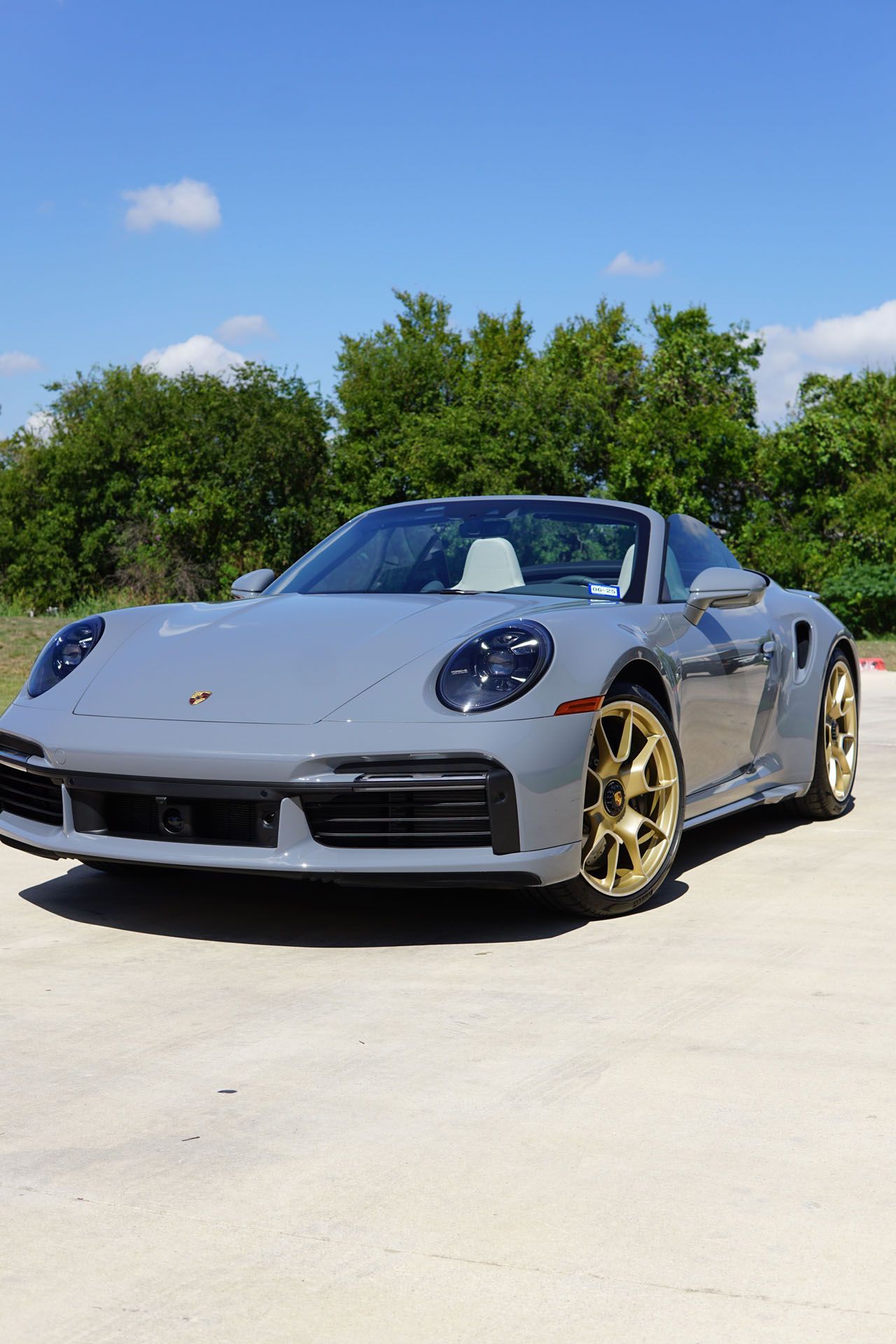 A yellow sports car is parked on the side of the road