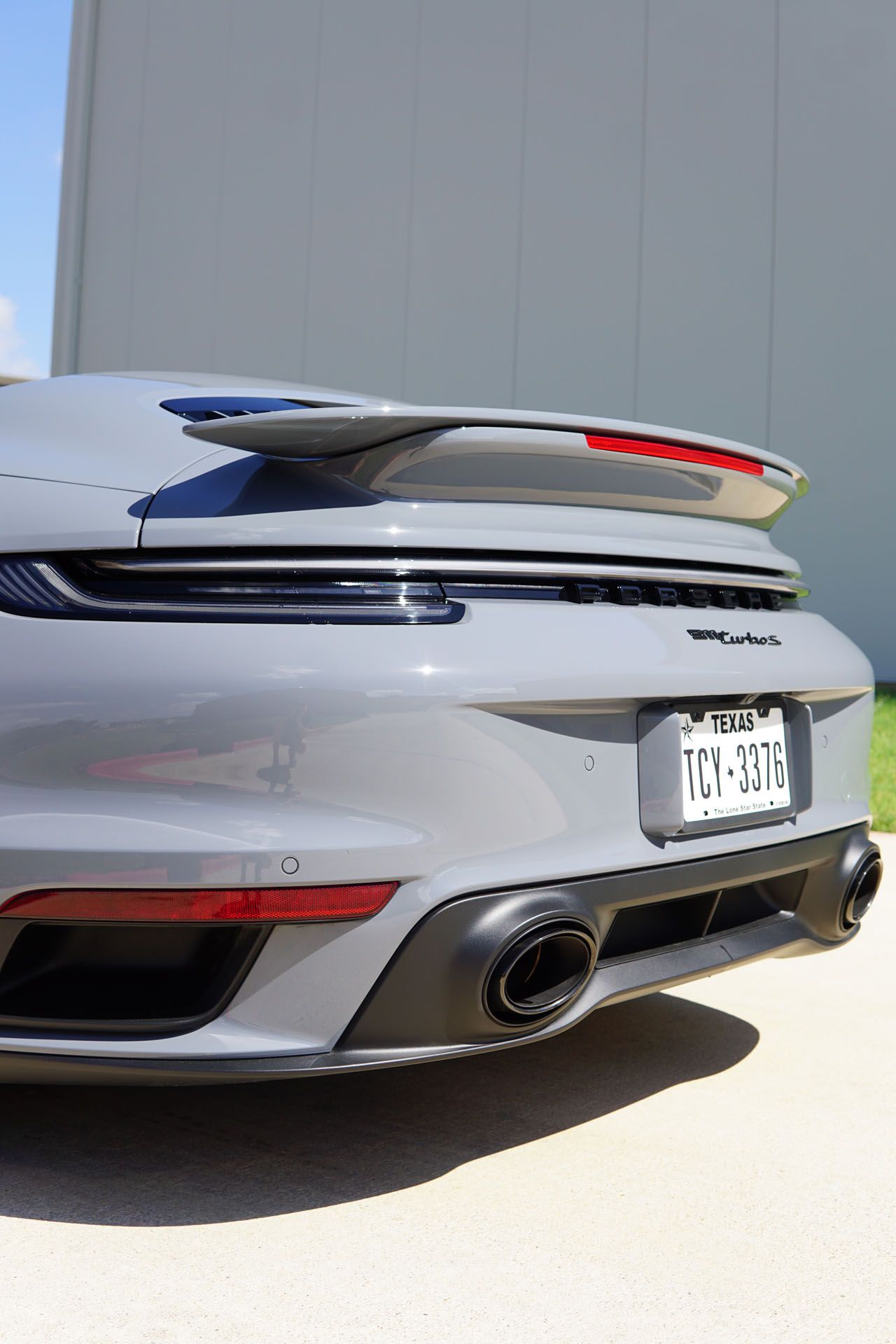 A yellow sports car is parked on the side of the road