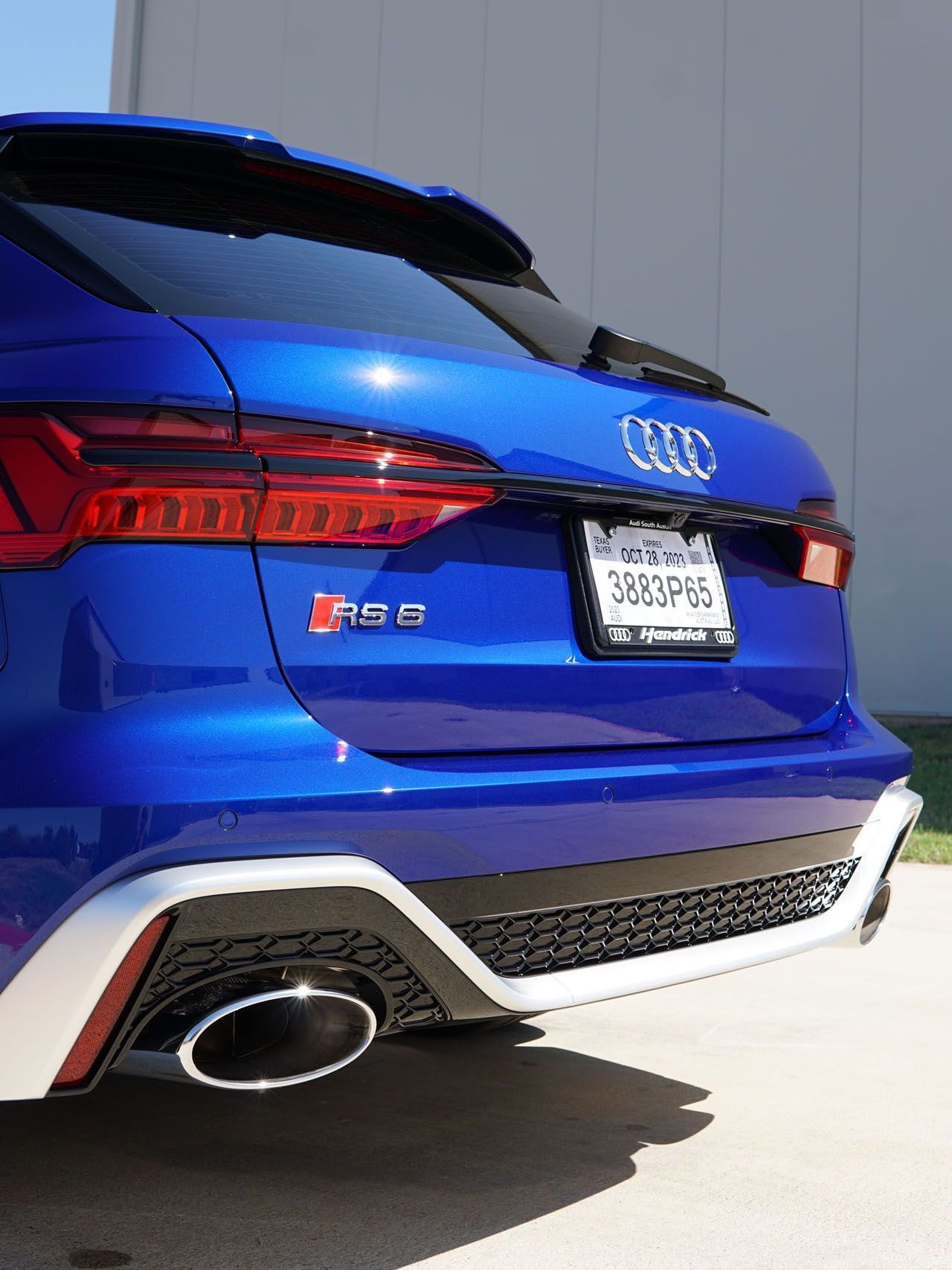 A blue audi rs6 is parked on the side of the road.