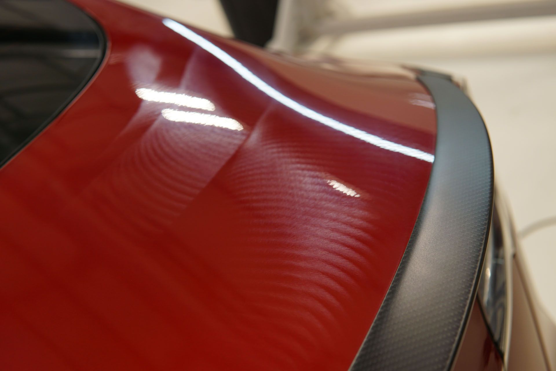 A close up of a red car with a black spoiler