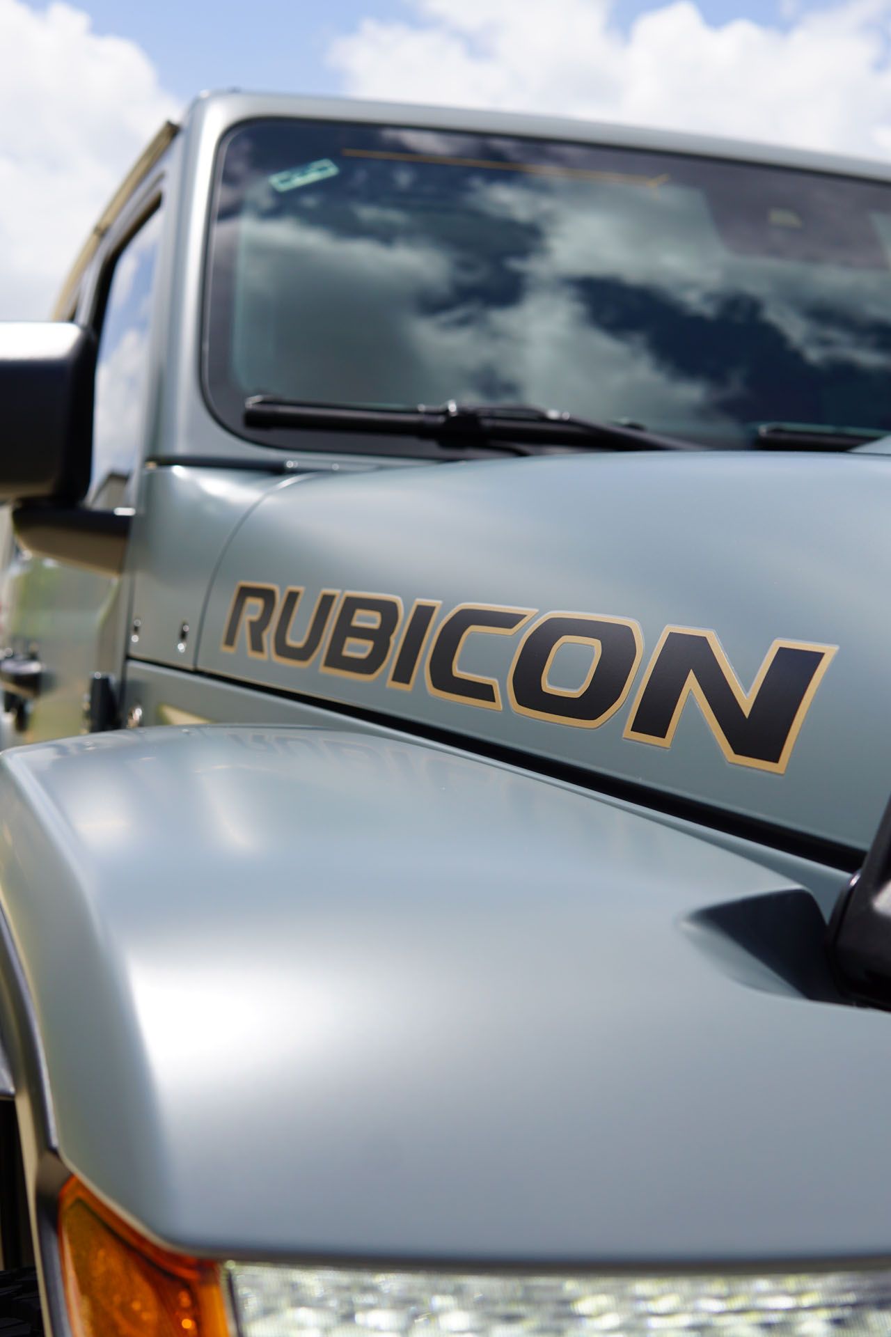 A silver jeep with the word rubicon on the hood