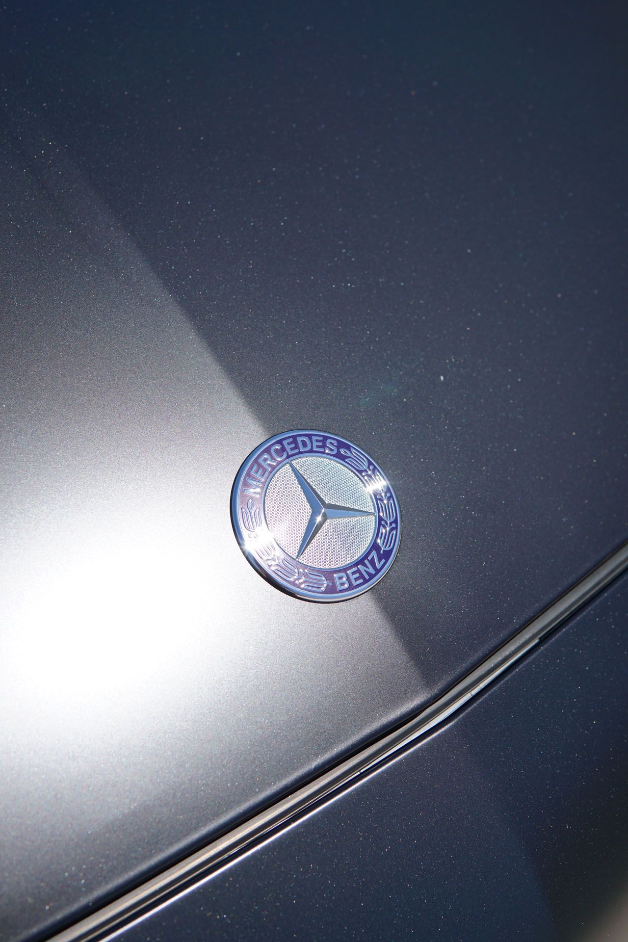 A close up of a car window with a reflection of a building