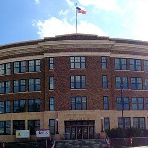 A large brick building with a flag on top of it