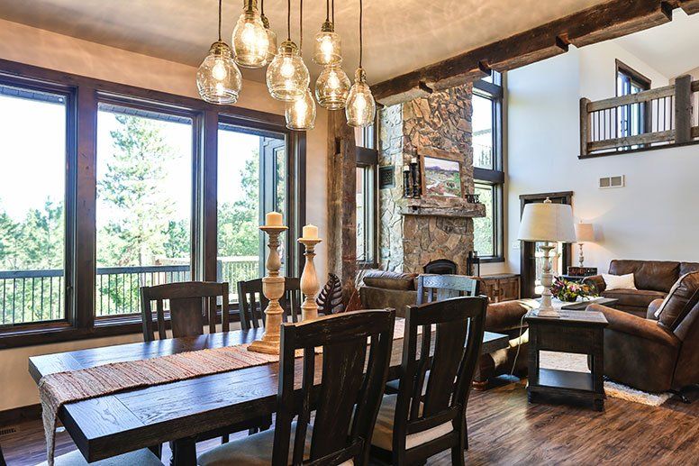 There is a dining table and chairs in the middle of the room.