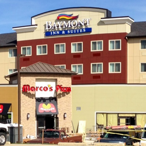 The baymont inn and suites has a restaurant in front of it