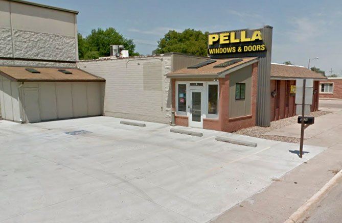 A building with a sign that says pella windows and doors