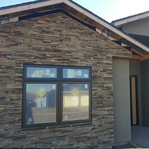A house with a stone wall and a window.