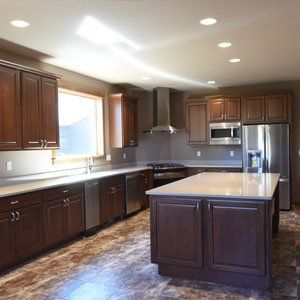 A kitchen with stainless steel appliances and wooden cabinets