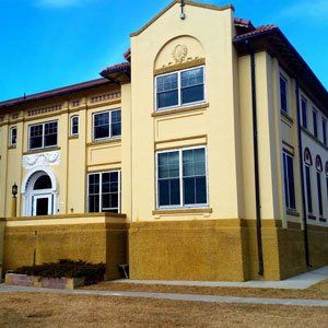 A large yellow building with a blue sky in the background