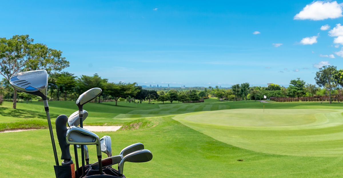 golf clubs on a golf course on a sunny day