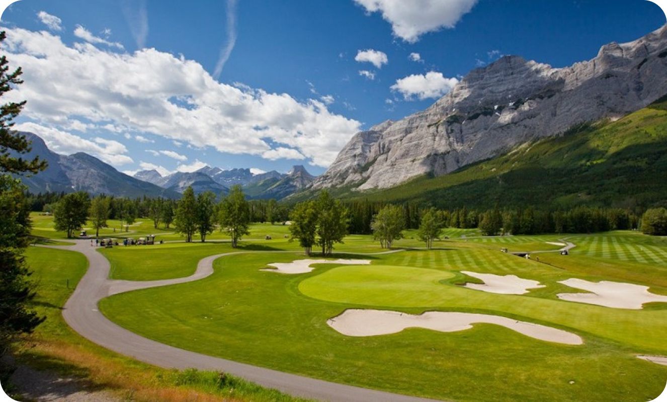 A golf course with mountains in the background
