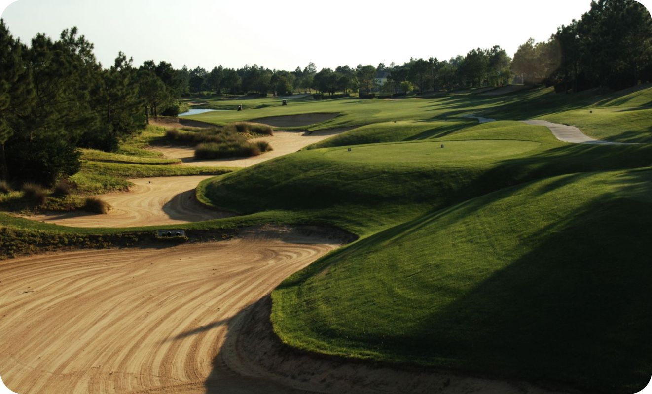 A golf course with a dirt road going through it