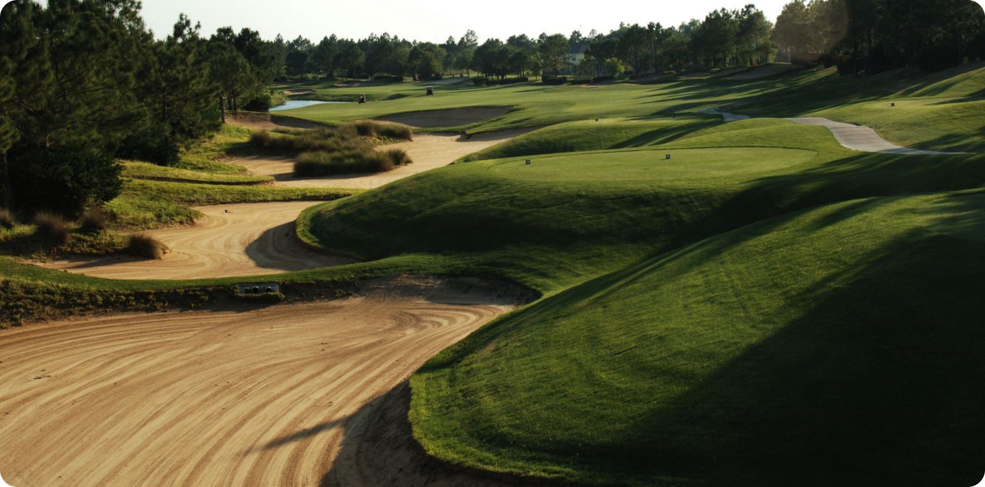 A golf course with a dirt road going through it
