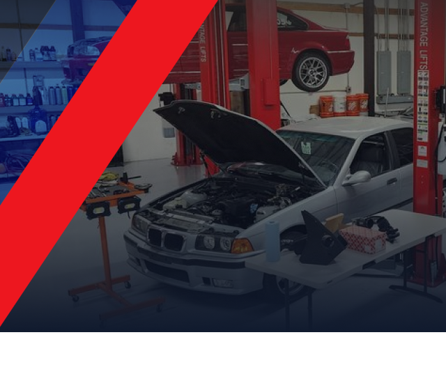 A car with the hood open is on a lift in a garage | Bavarian Auto Clinic