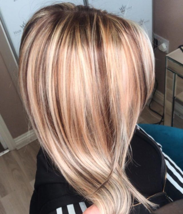 Hair styled with blonde highlights and brown lowlights.