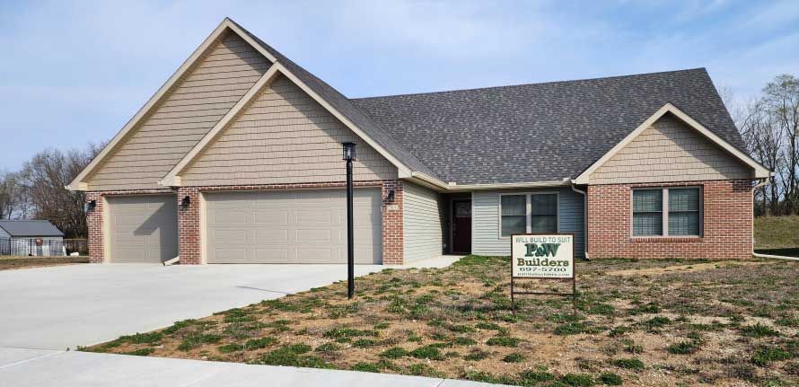 A house with a sign in front of it that says for sale