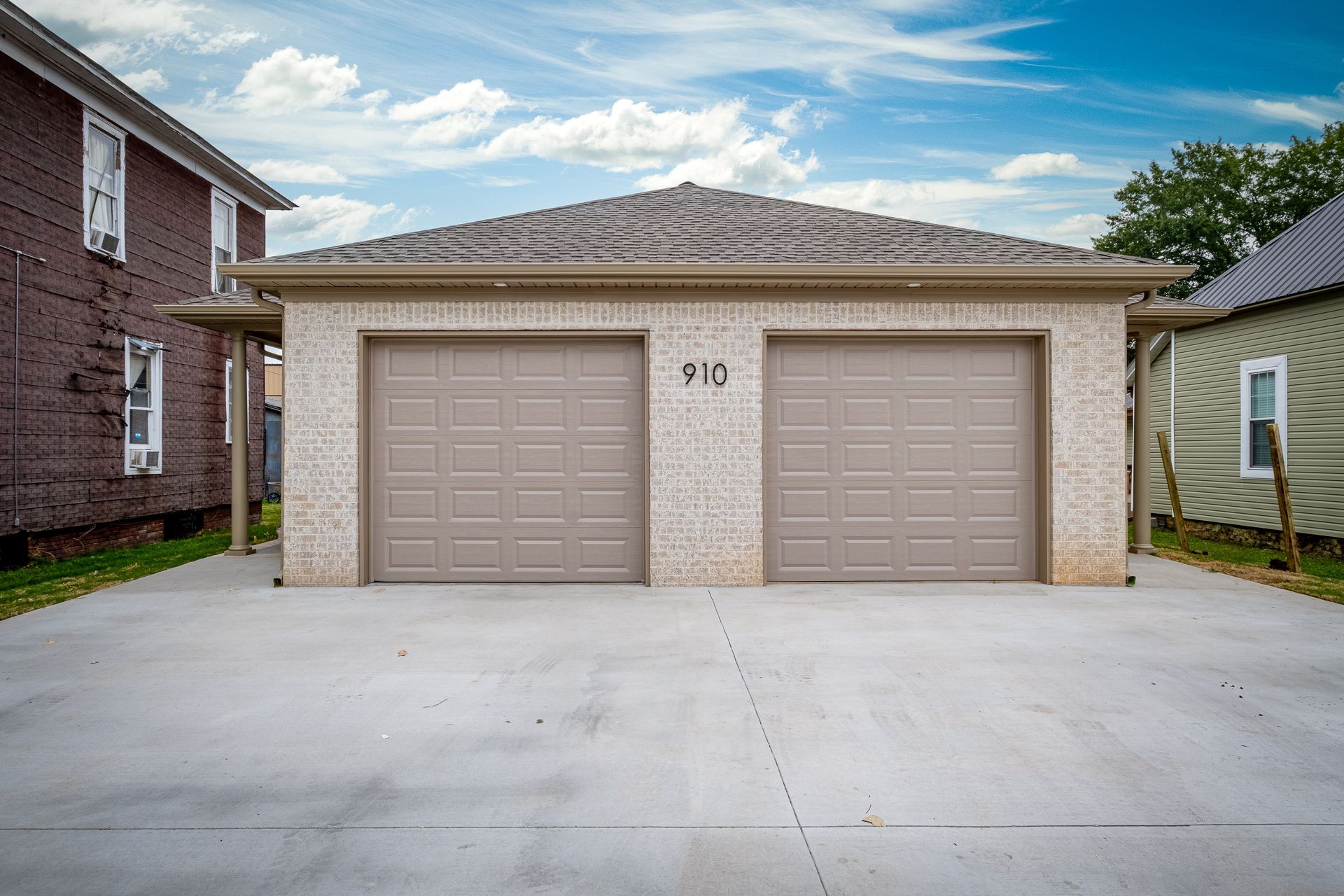 There are two garage doors in front of a house.