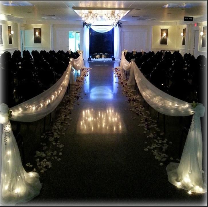 A wedding ceremony is being held in a large room