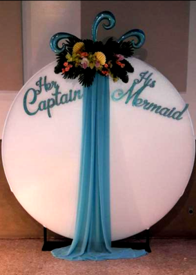 A sign that says her captain and his mermaid