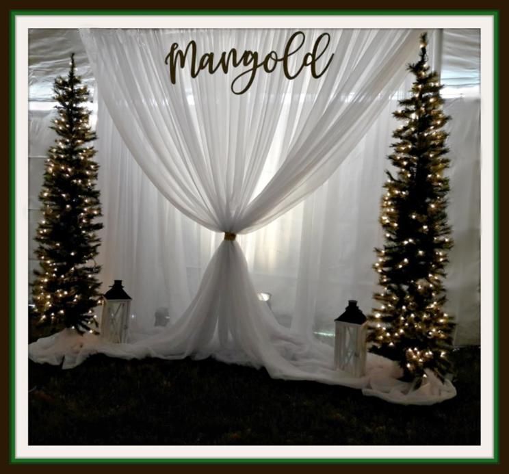 A white curtain with the name mangold on it