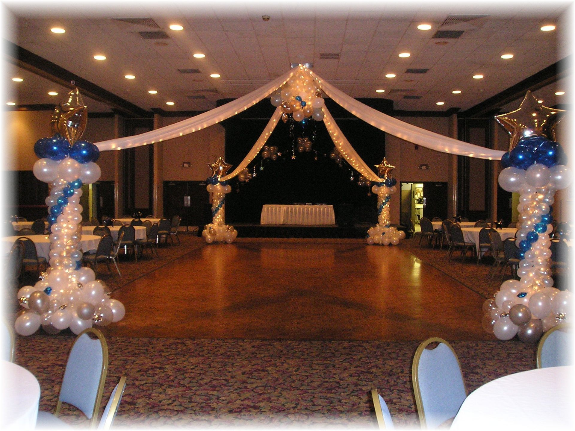 A large room decorated with blue and white balloons