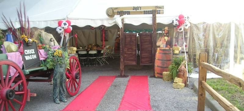 A red carpet is leading to a cowboy themed event