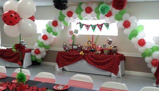 A room decorated with red , white and green balloons