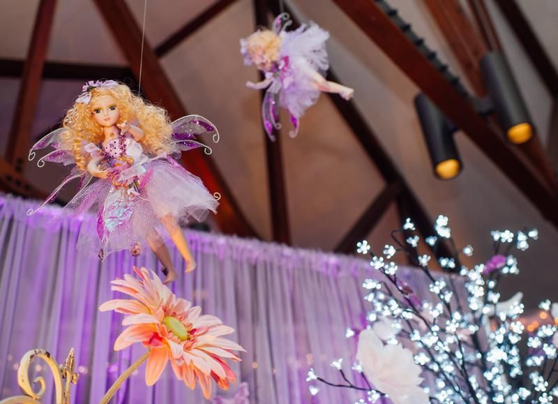 Fairy dolls are hanging from the ceiling in a room