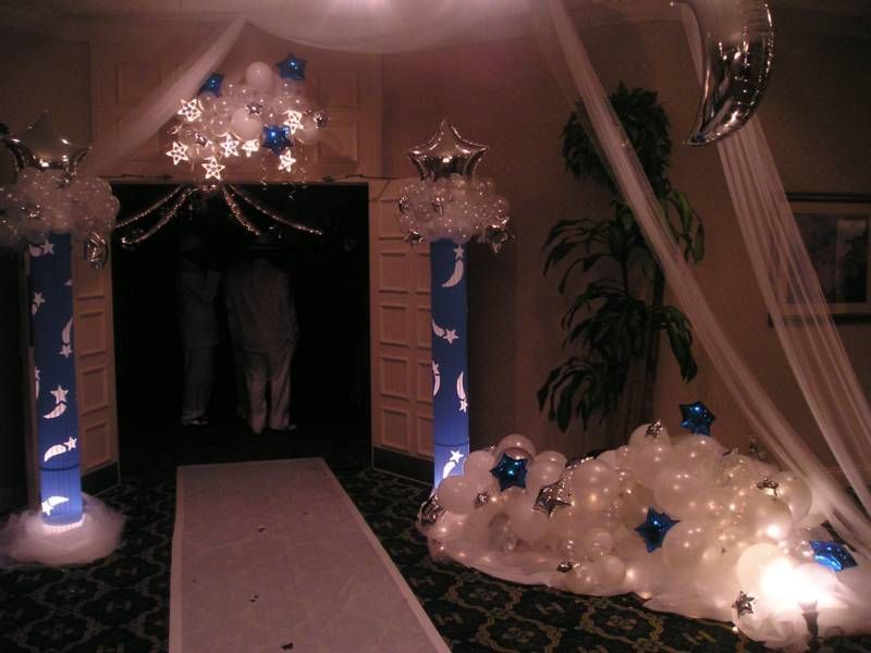 A room decorated with blue and white balloons and stars