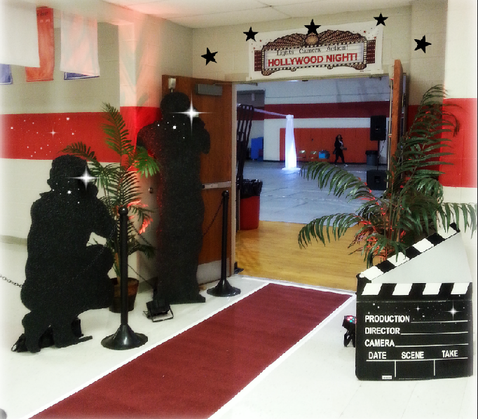 A sign that says hollywood night is above a red carpet